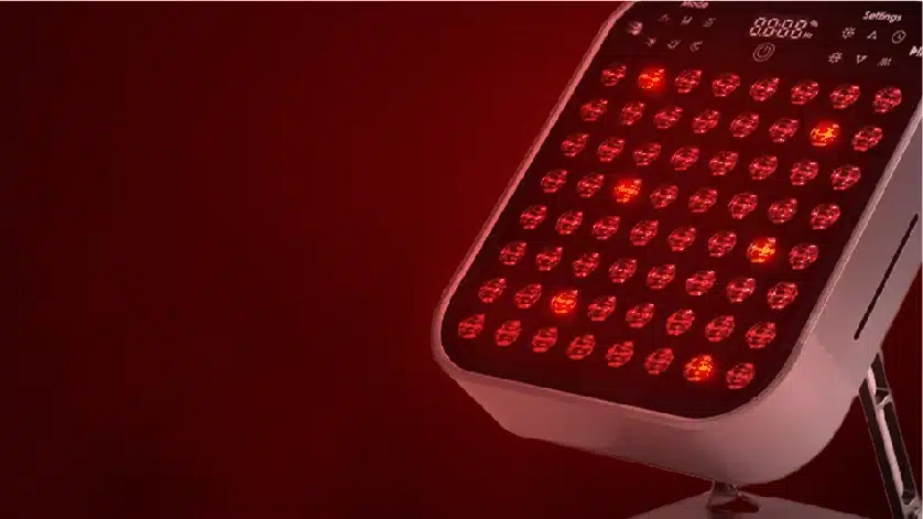 A red led light sitting on top of a table.