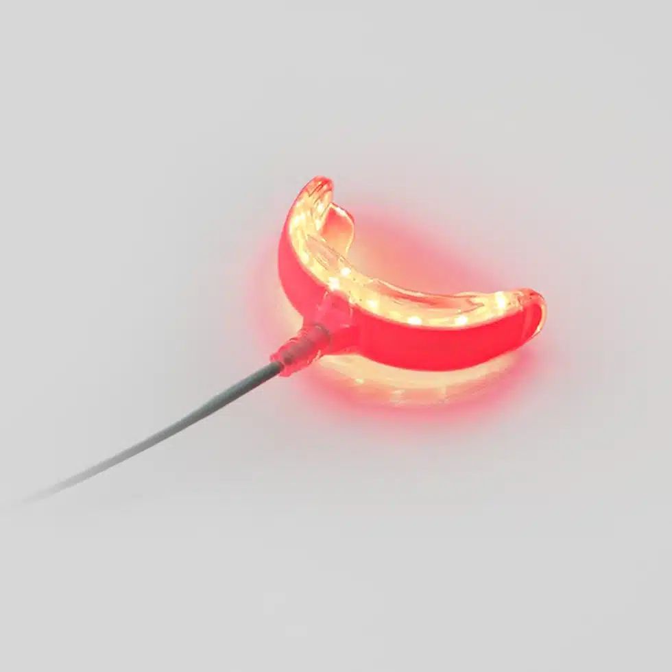 A REDi Lumident with Power Pack on a white surface.